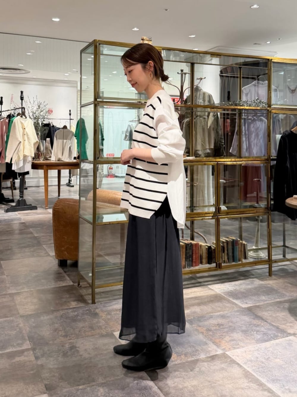 ブラック系のその他パンツ、ホワイト系のニット/セーターを着用したレディースの冬コーディネートの2枚目の写真