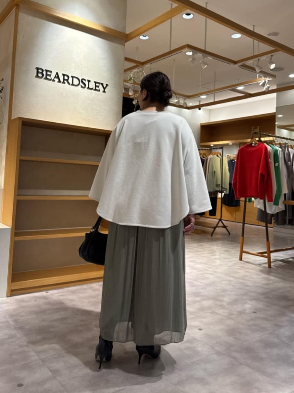 グリーン系のその他パンツ、ブラック系のブーツ、ブラック系のトートバッグを着用したレディースの冬コーディネートの4枚目の写真