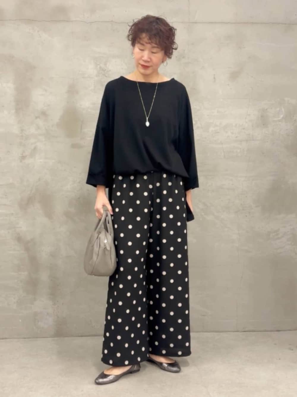 グレー系のボストンバッグ、ブラック系のTシャツ/カットソー、ブラック系のその他パンツを着用したレディースの冬コーディネートの4枚目の写真