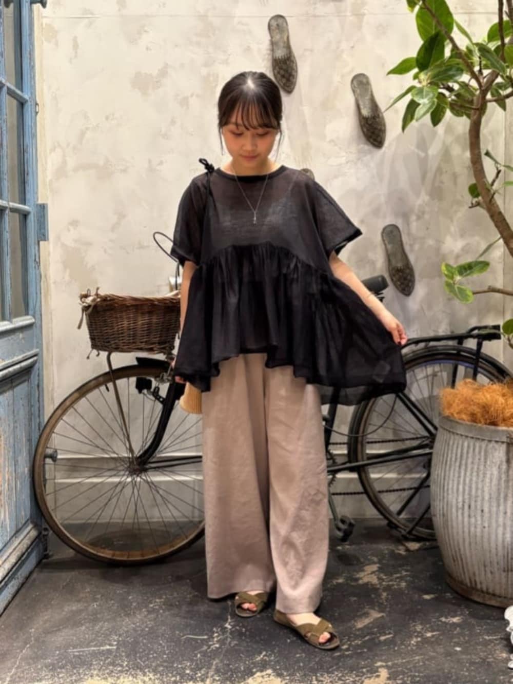 グレー系のその他パンツ、ブラック系のニット/セーターを着用したレディースの春コーディネートの6枚目の写真