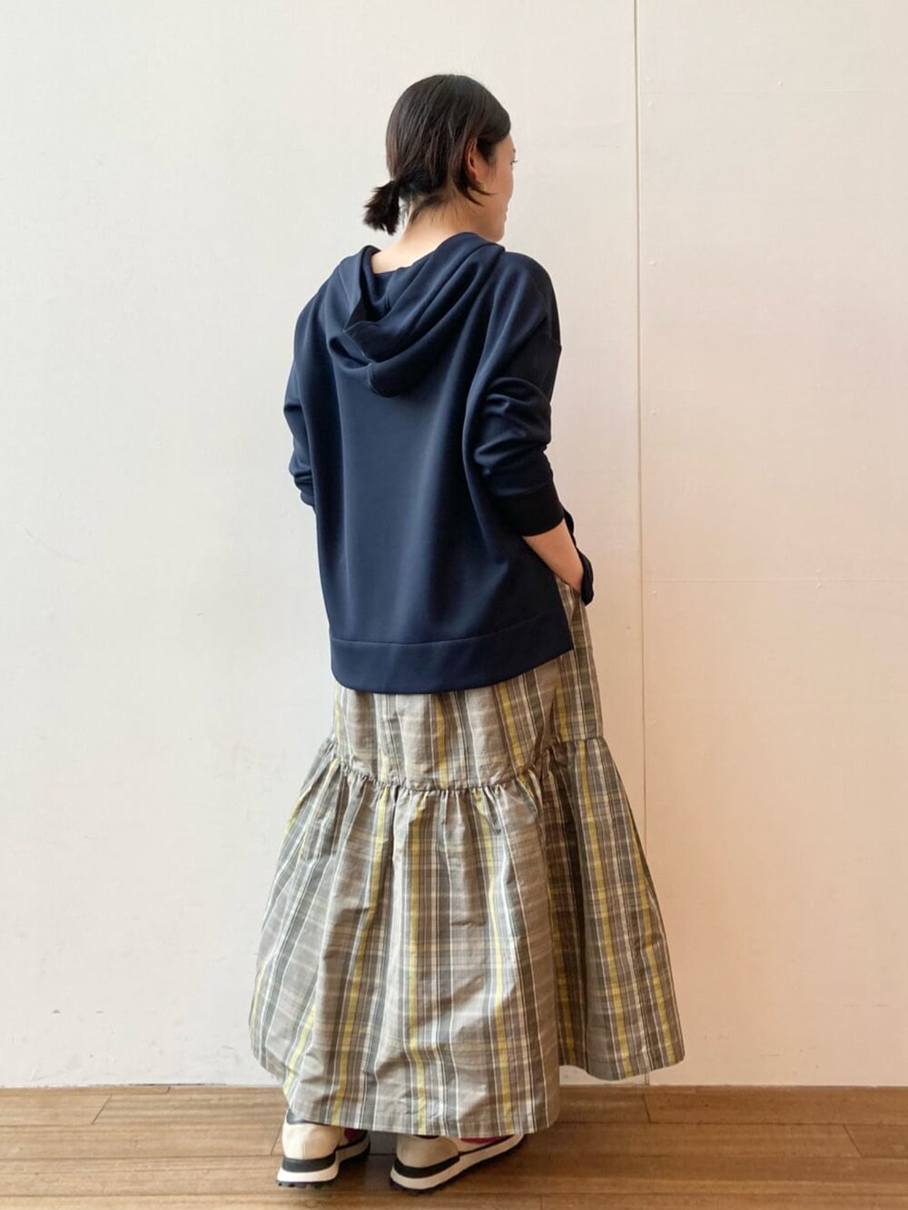 ブルー系のパーカー、グレー系のスカートを着用したレディースの春コーディネートの2枚目の写真