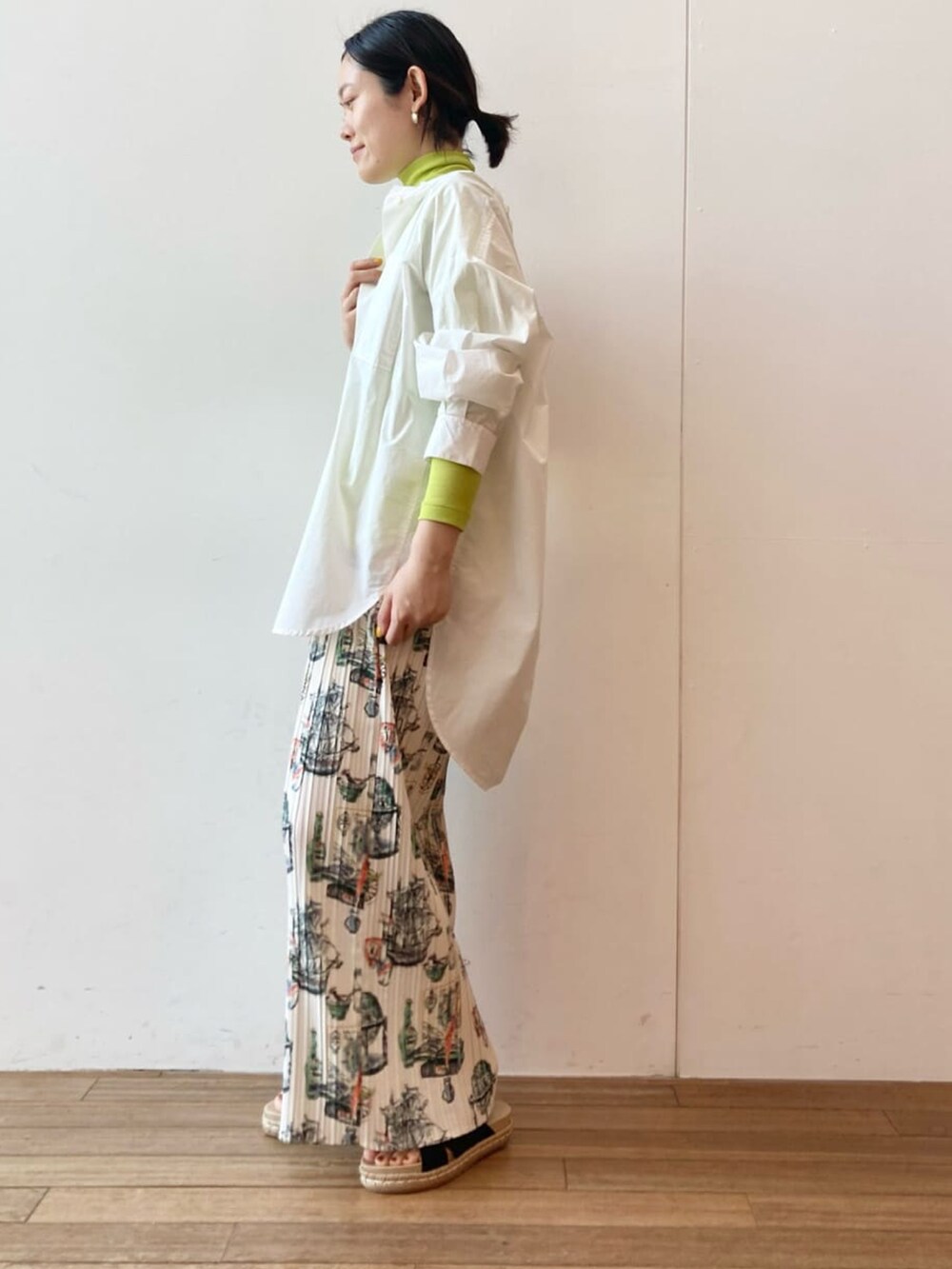 ベージュ系のその他パンツ、ホワイト系のシャツ/ブラウス、イエロー系のTシャツ/カットソーを着用したレディースの春コーディネートの2枚目の写真