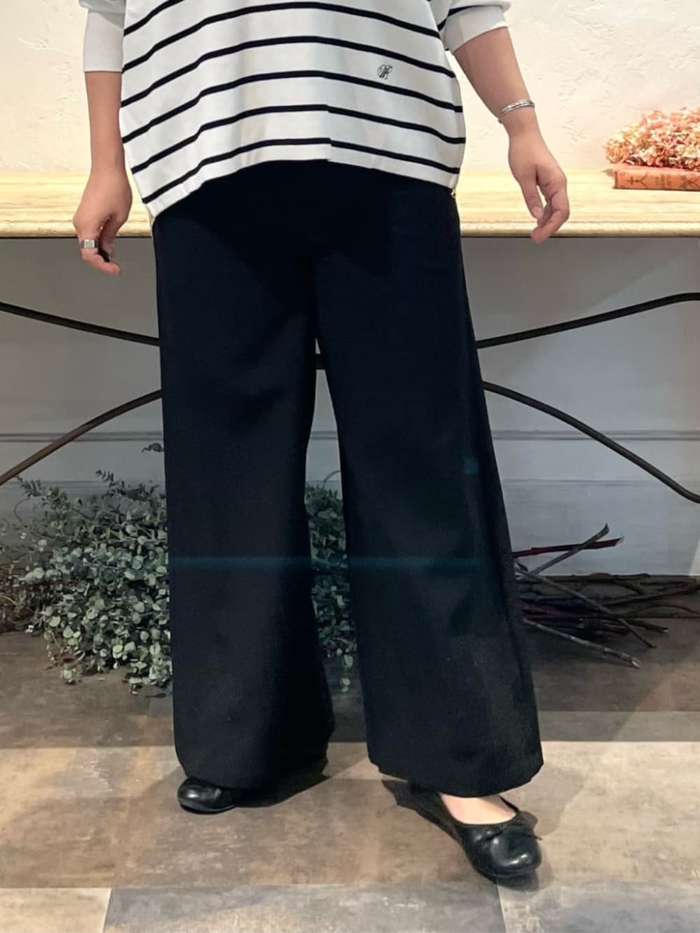 ブラック系のその他パンツ、グレー系のショルダーバッグ、ホワイト系のニット/セーターを着用したレディースの冬コーディネートの8枚目の写真