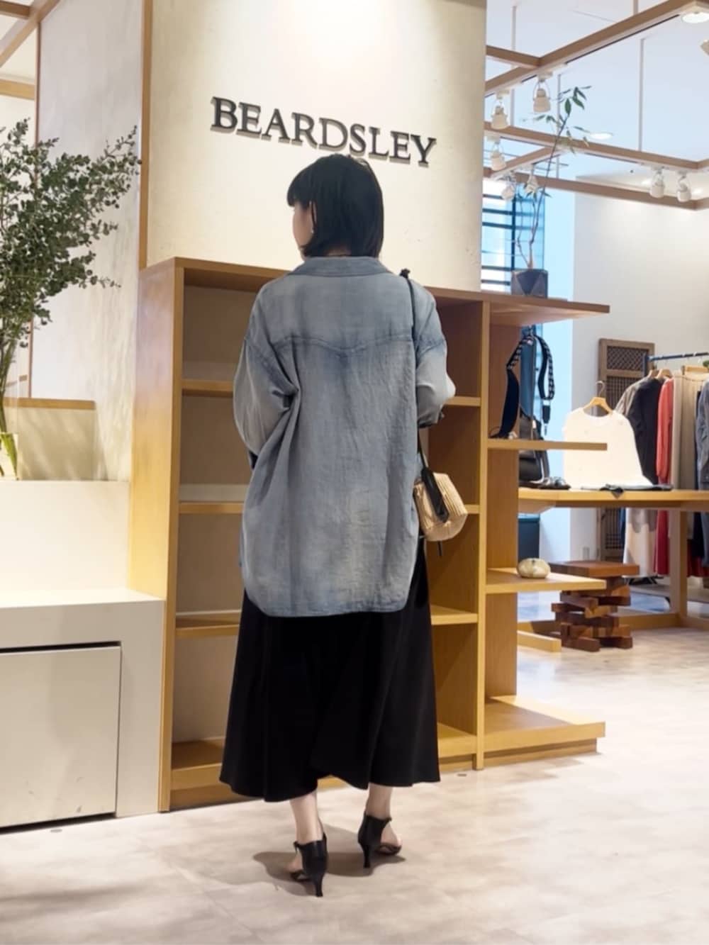 ブルー系のシャツ/ブラウス、ブラック系のワンピースを着用したレディースの春コーディネートの5枚目の写真