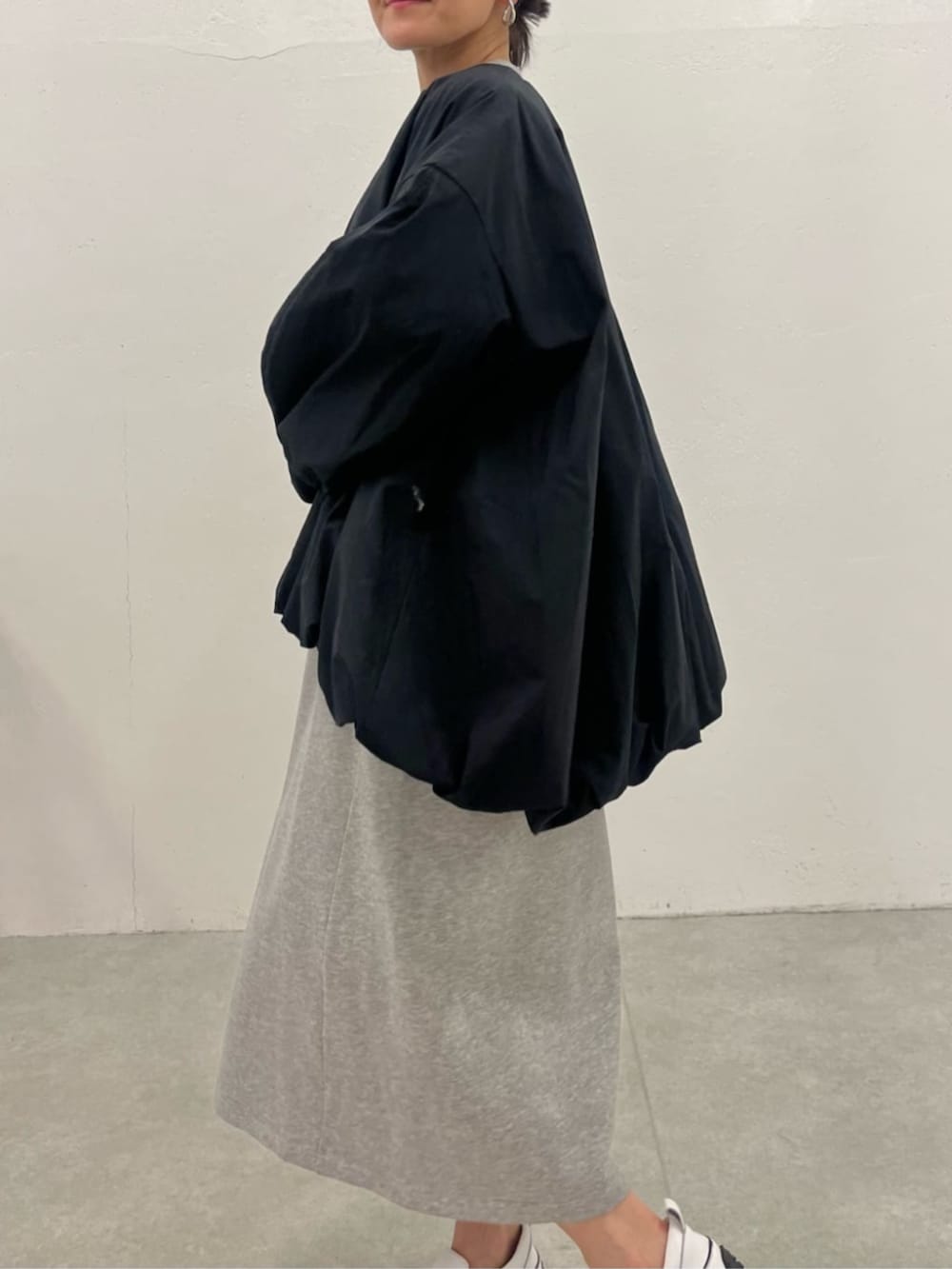 ブラック系のブルゾン、グレー系のワンピースを着用したレディースの冬コーディネートの10枚目の写真