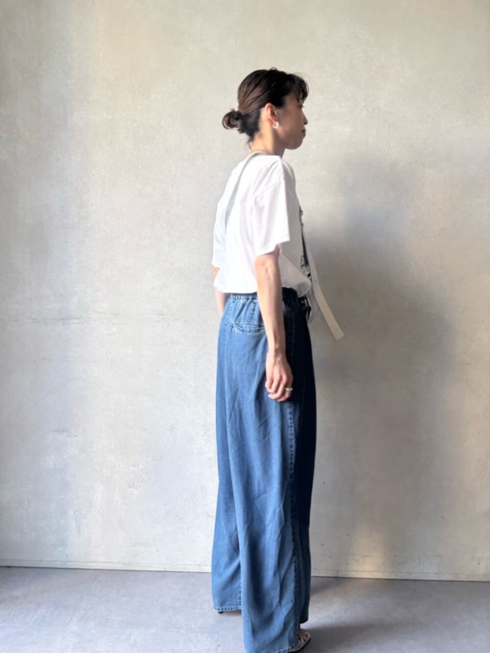 シルバー系のショルダーバッグ、ブルー系のその他パンツ、ホワイト系のTシャツ/カットソーを着用したレディースの春コーディネートの3枚目の写真