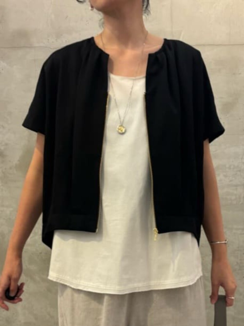 ベージュ系のその他パンツ、ホワイト系のシャツ/ブラウス、ブラック系のベストを着用したレディースの春コーディネートの10枚目の写真