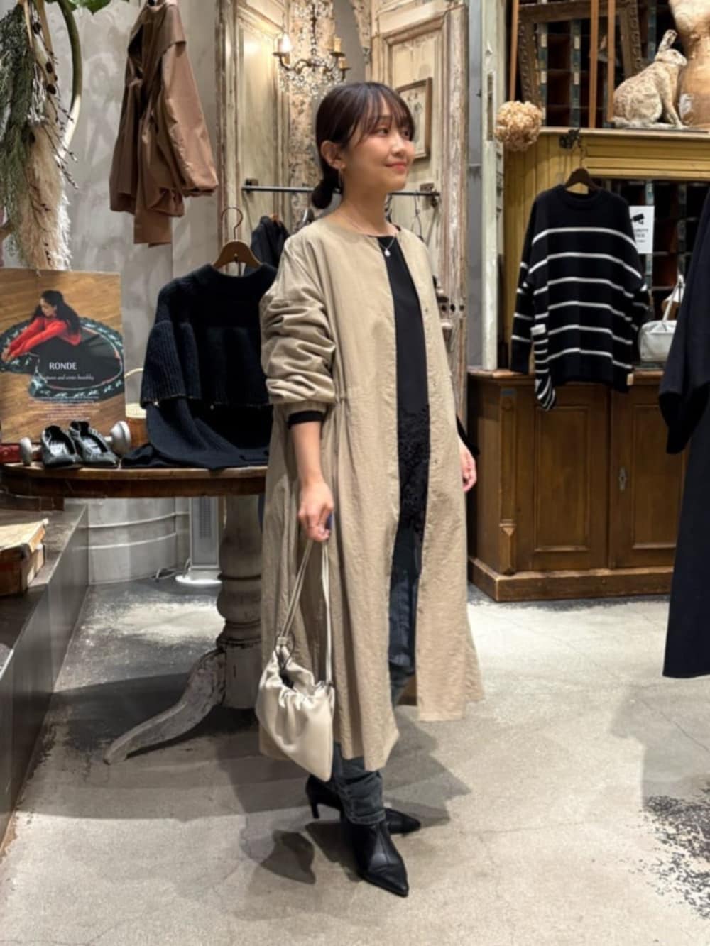 ベージュ系のその他アウター、ブルー系のデニムパンツを着用したレディースの冬コーディネートの5枚目の写真