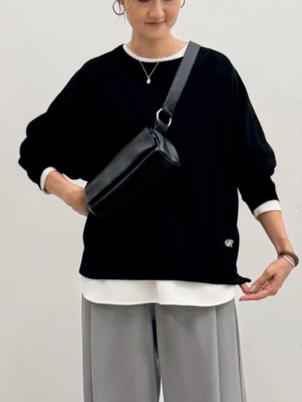 ブラック系のショルダーバッグ、ブラック系のTシャツ/カットソー、グレー系のその他パンツを着用したレディースの夏コーディネートの7枚目の写真