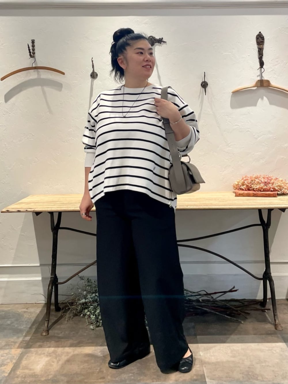 ブラック系のその他パンツ、グレー系のショルダーバッグ、ホワイト系のニット/セーターを着用したレディースの冬コーディネートの3枚目の写真