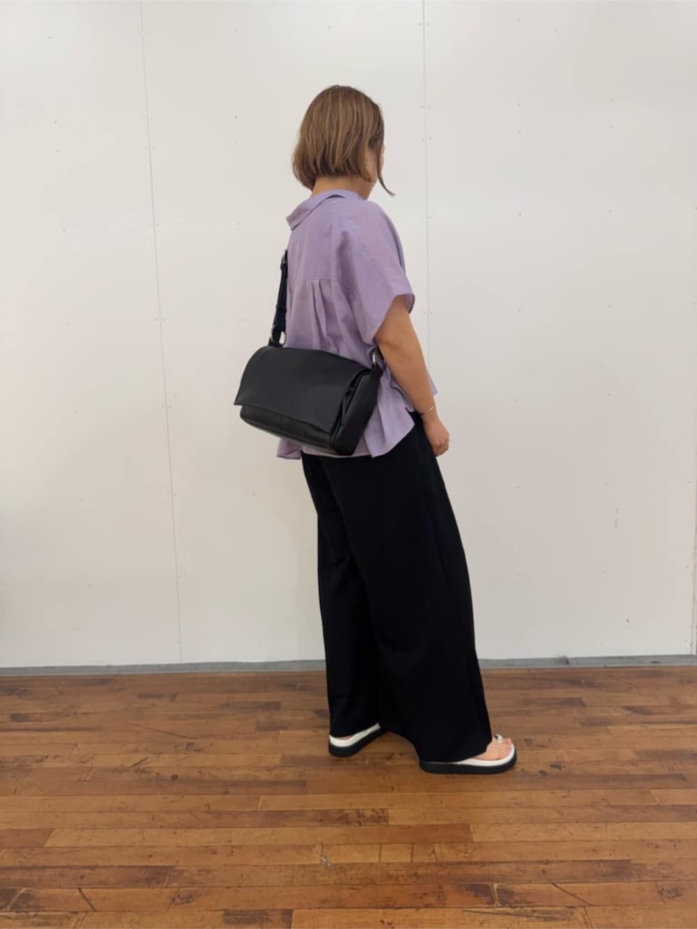 ブラック系のその他パンツ、ホワイト系のサンダル、ブラック系のショルダーバッグを着用したレディースの春コーディネートの4枚目の写真