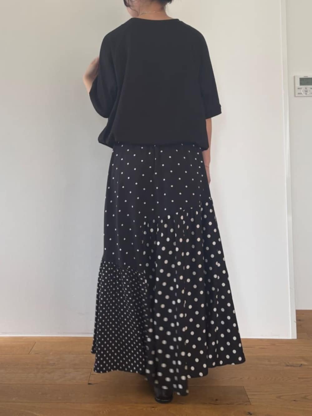 ブラック系のスカート、ブラック系のTシャツ/カットソーを着用したレディースの夏コーディネートの4枚目の写真