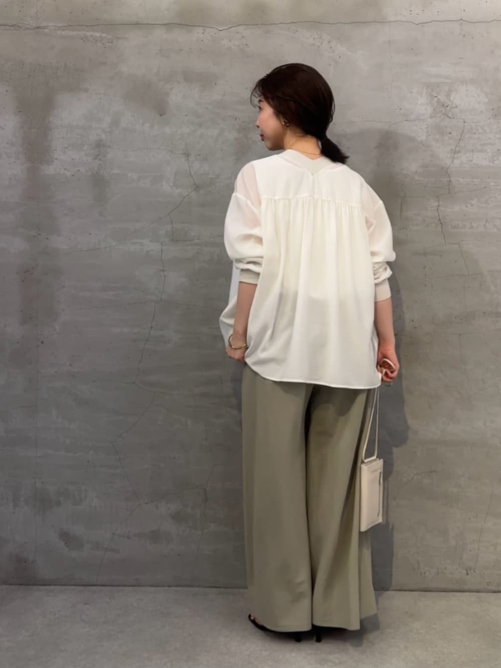 グリーン系のその他パンツ、ホワイト系のシャツ/ブラウス、ホワイト系のタンクトップを着用したレディースの春コーディネートの3枚目の写真