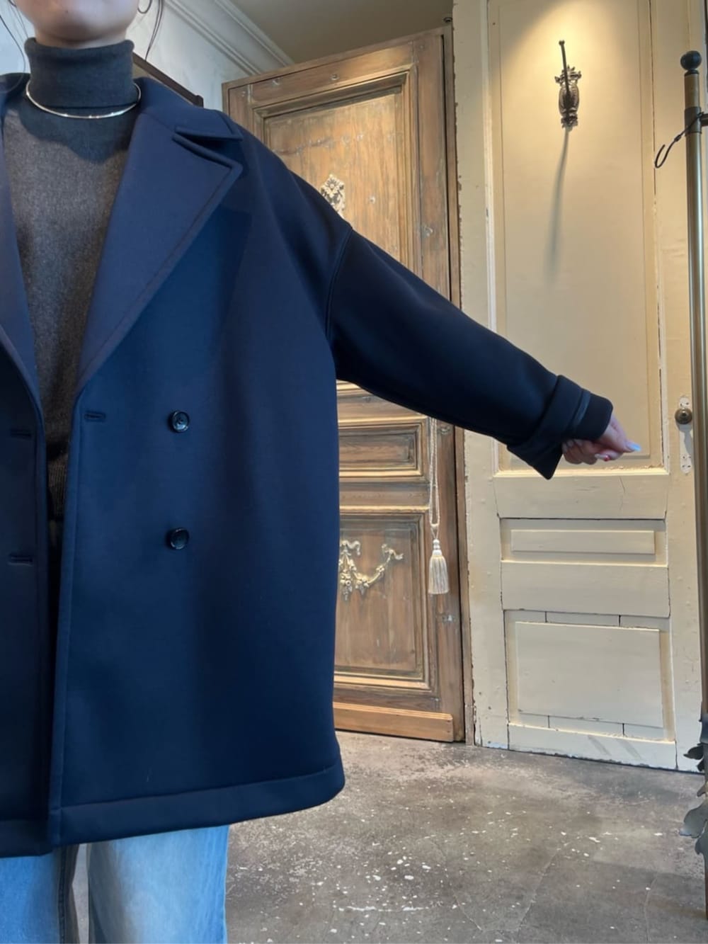 グレー系のニット/セーター、ブルー系のピーコートを着用したレディースの冬コーディネートの8枚目の写真