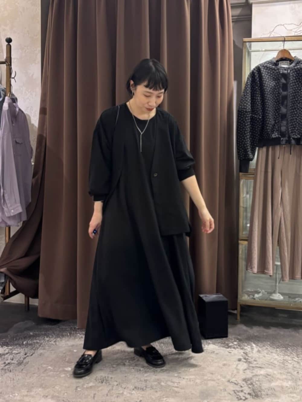 ブラック系のワンピース、ブラック系のその他アウターを着用したレディースの春コーディネートの5枚目の写真