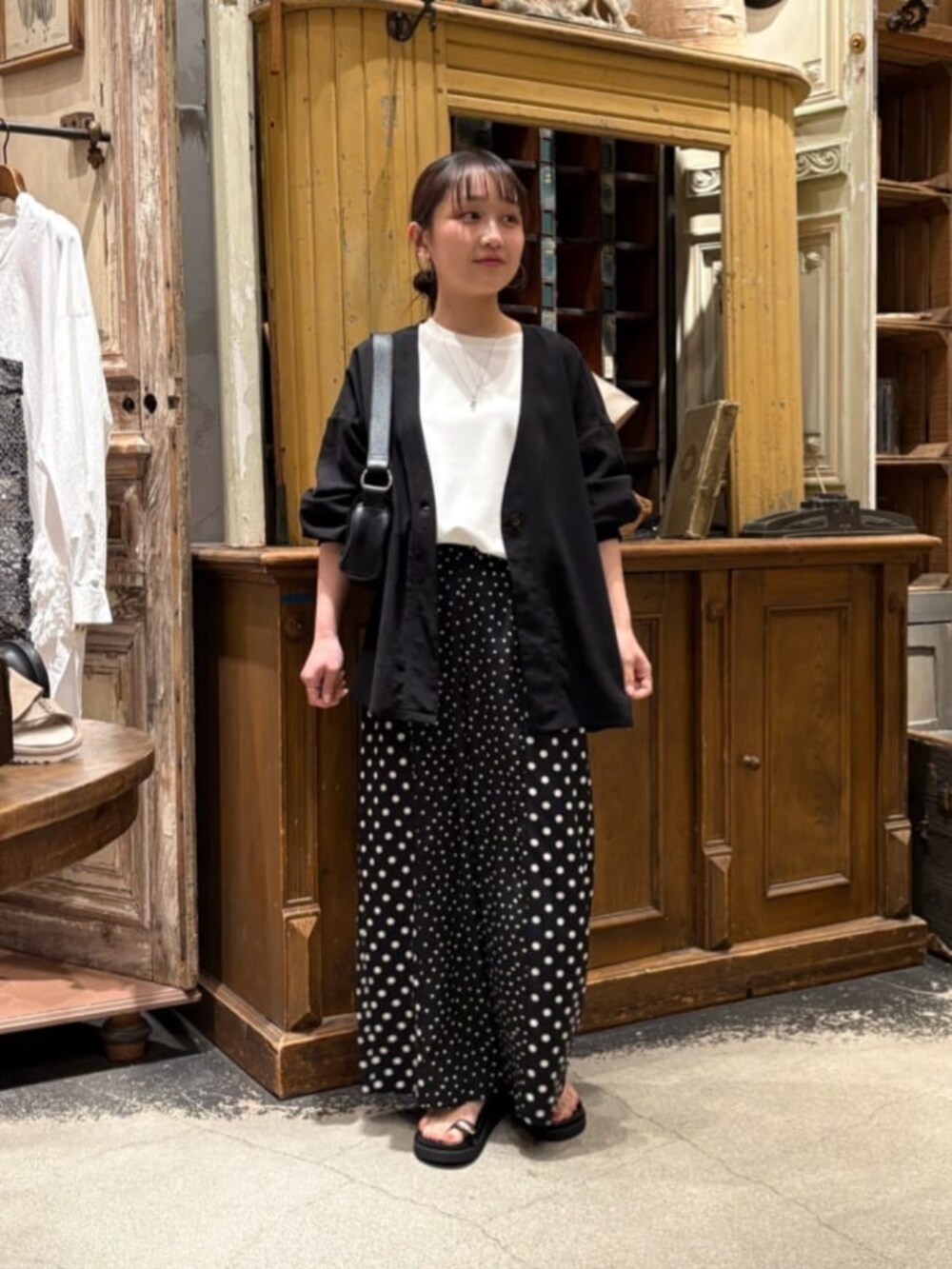 ブラック系のその他パンツ、ブラック系のその他アウター、ブラック系のサンダルを着用したレディースの春コーディネートの2枚目の写真