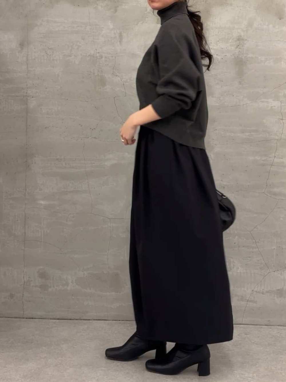 グレー系のニット/セーター、ブラック系のスカートを着用したレディースの冬コーディネートの4枚目の写真