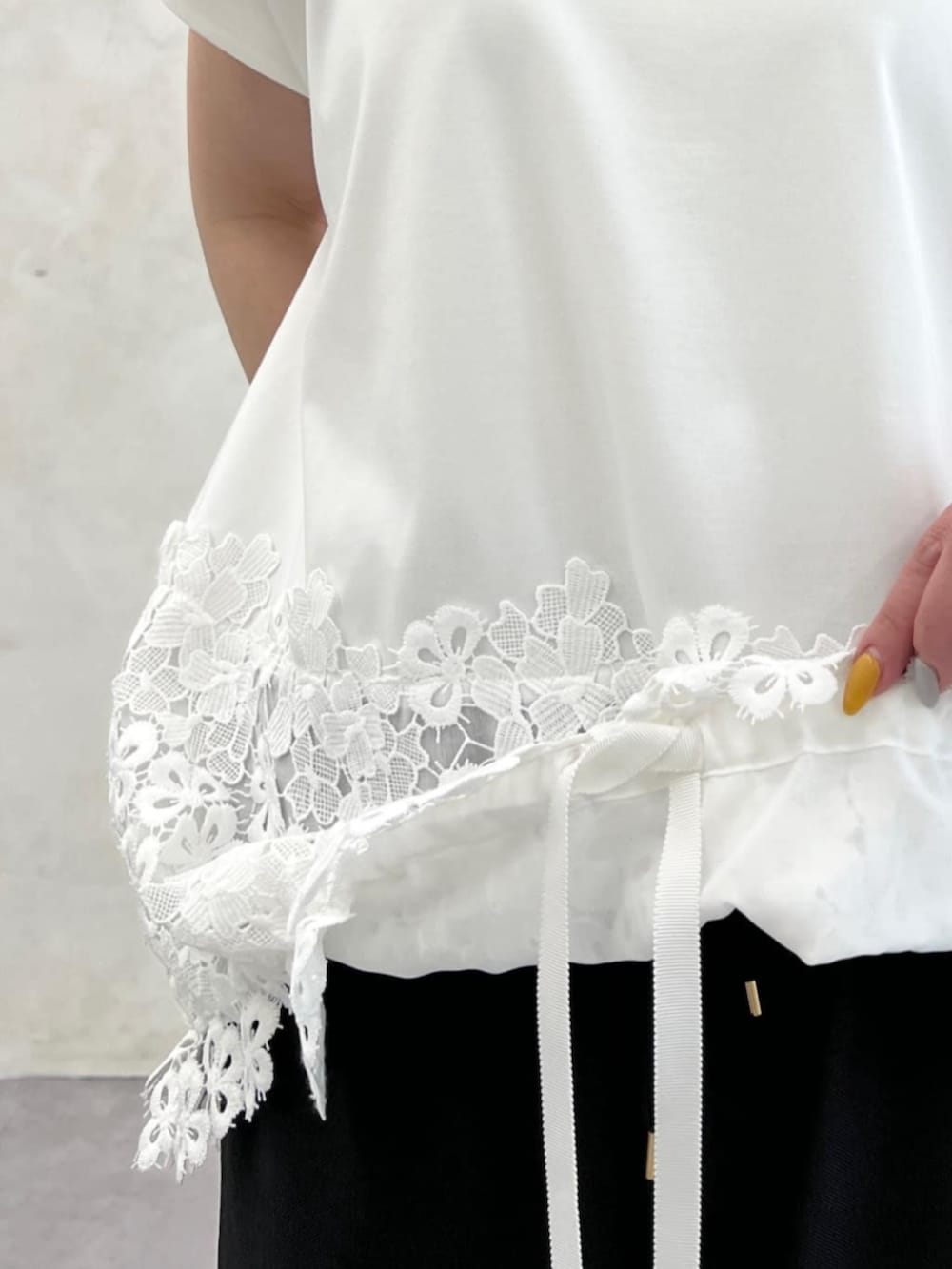 ホワイト系のトートバッグ、ブラック系のその他パンツ、ホワイト系のTシャツ/カットソーを着用したレディースの春コーディネートの5枚目の写真