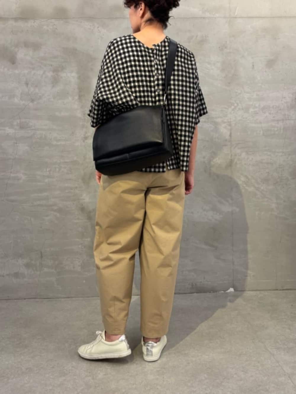 ブラック系のショルダーバッグを着用したレディースの春コーディネートの2枚目の写真