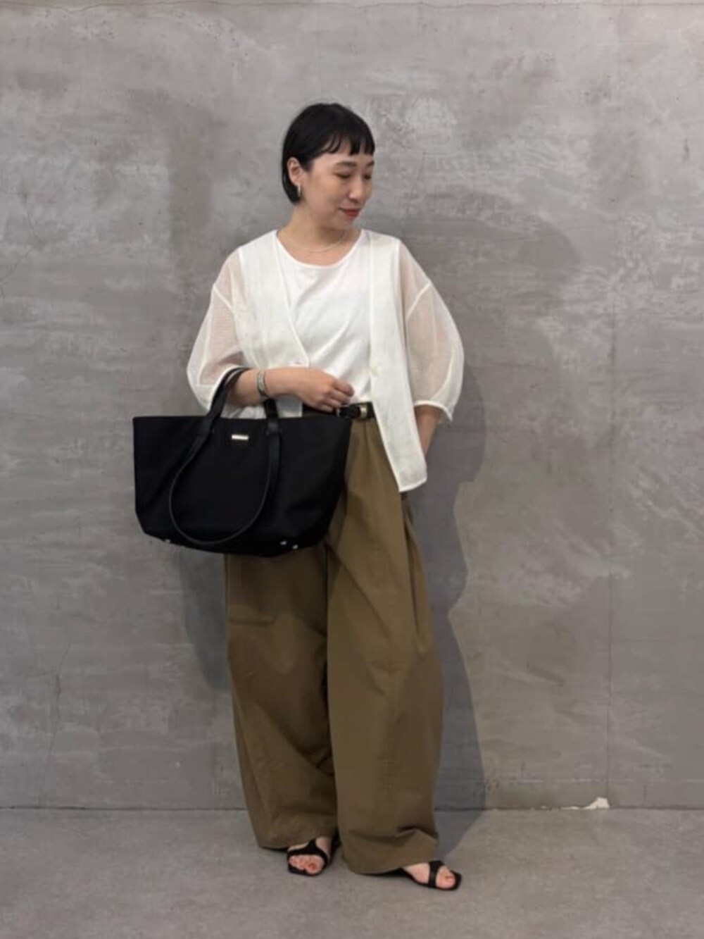 イエロー系のその他パンツ、ホワイト系のシャツ/ブラウス、ブラック系のトートバッグを着用したレディースの春コーディネートの3枚目の写真