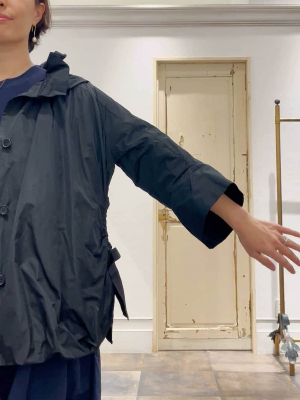 ブラック系のボストンバッグ、ブラック系のブルゾン、ブルー系のワンピースを着用したレディースの冬コーディネートの7枚目の写真