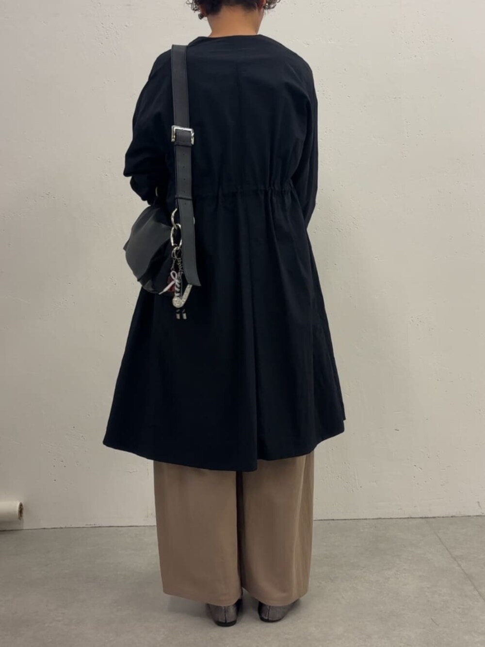 ブルー系のその他アウター、ベージュ系のその他パンツ、ブラック系のTシャツ/カットソーを着用したレディースの冬コーディネートの4枚目の写真