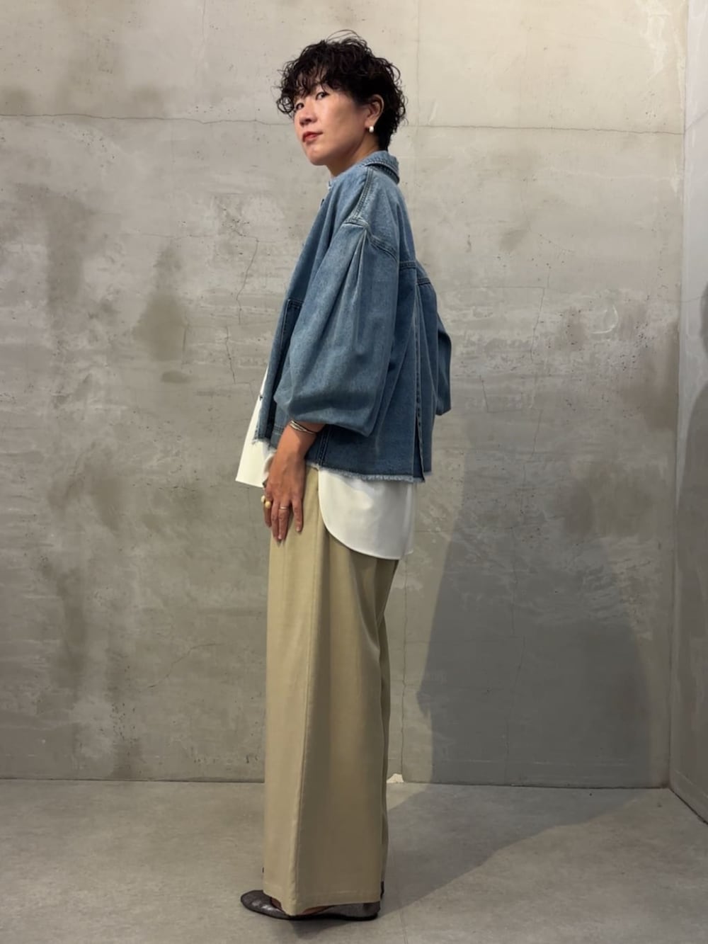 ブルー系のデニムジャケット、ベージュ系のその他パンツ、ホワイト系のシャツ/ブラウスを着用したレディースの冬コーディネートの4枚目の写真