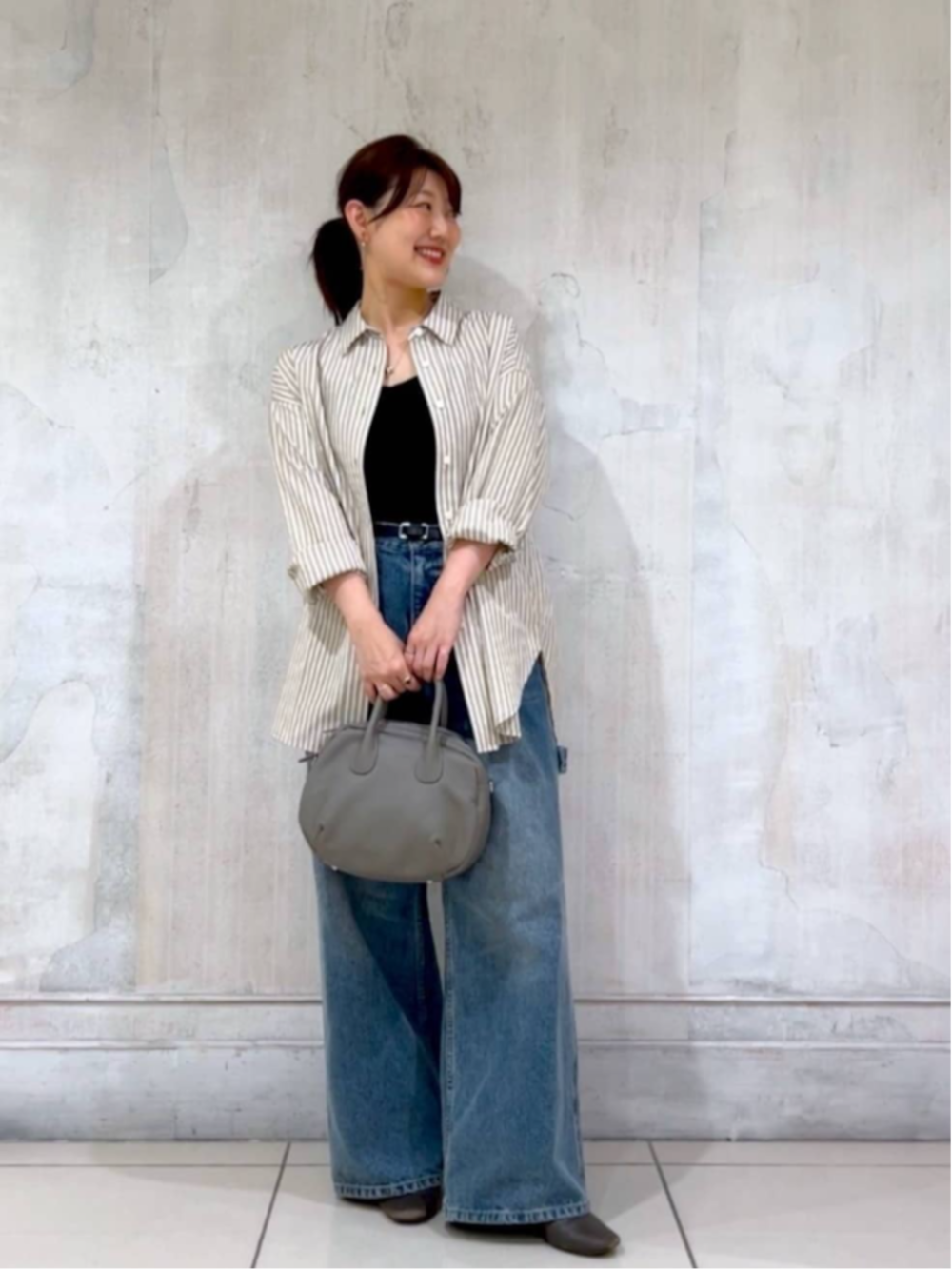 ブルー系のデニムパンツ、ベージュ系のシャツ/ブラウスを着用したレディースの秋コーディネートの7枚目の写真