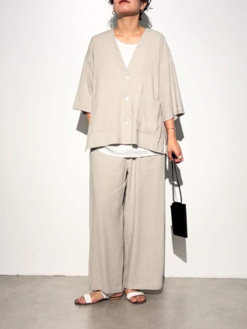 ブラック系のショルダーバッグ、ベージュ系のその他パンツ、ベージュ系のその他アウターを着用したレディースの春コーディネートの2枚目の写真