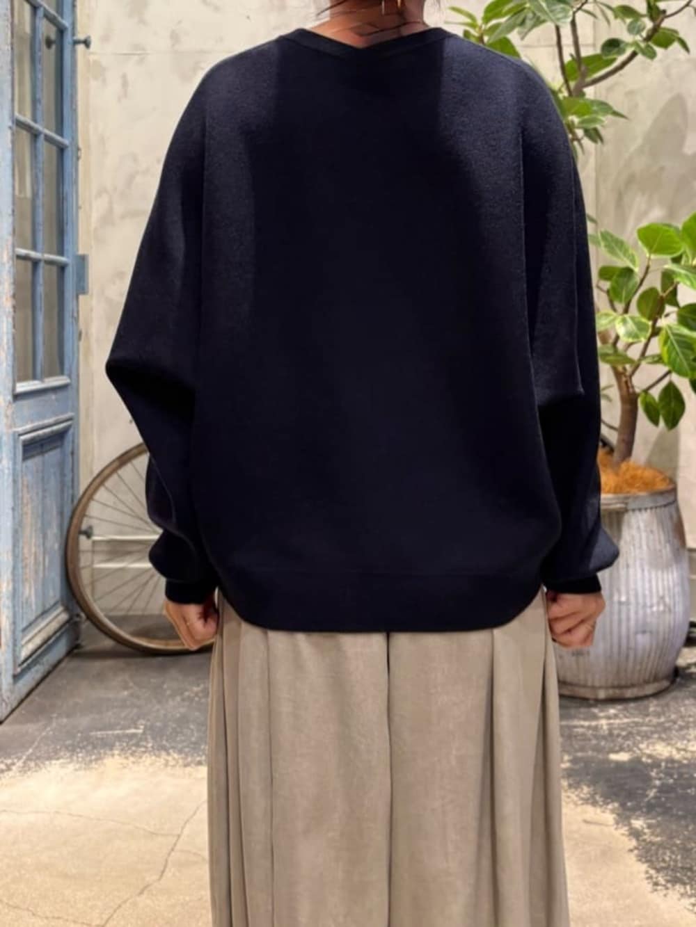 ブルー系のニット/セーター、グレー系のその他パンツを着用したレディースの夏コーディネートの10枚目の写真