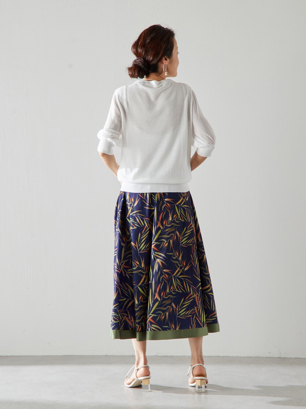 ホワイト系のニット/セーター、ブルー系のスカートを着用したレディースの夏コーディネートの3枚目の写真