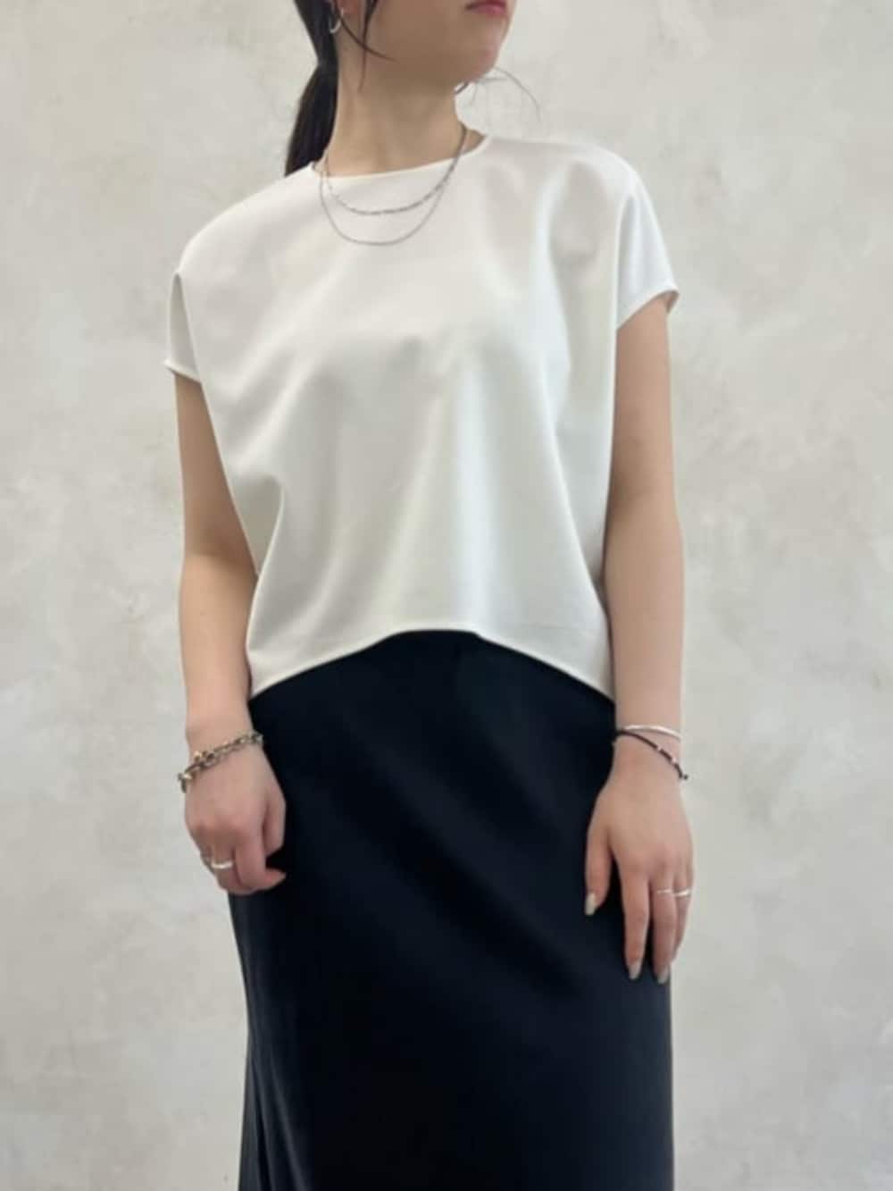 ブラック系のトートバッグ、ベージュ系のテーラードジャケット、ベージュ系のスカートを着用したレディースの春コーディネートの4枚目の写真