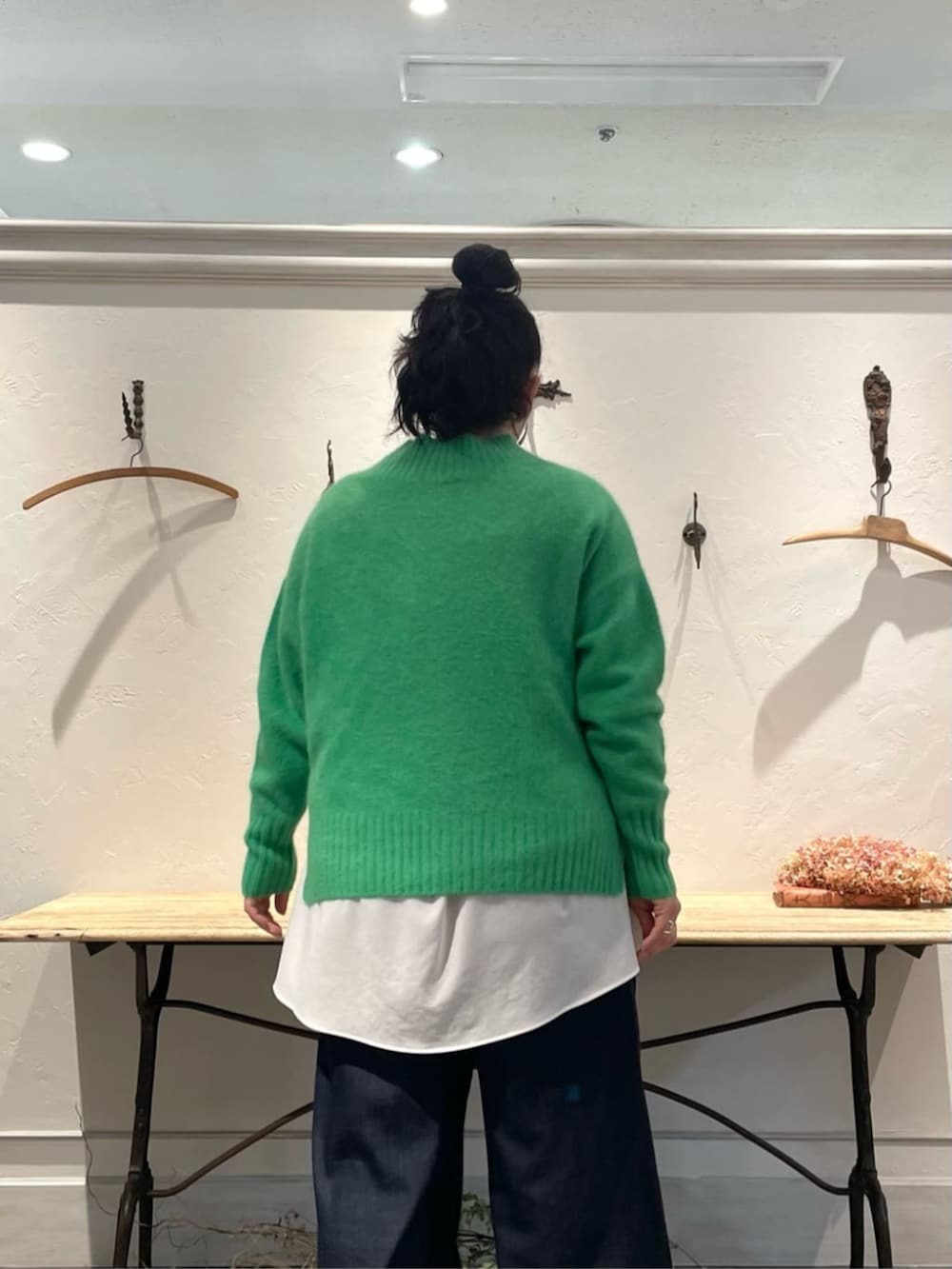 ホワイト系のTシャツ/カットソー、グリーン系のニット/セーター、ブルー系のその他パンツを着用したレディースの冬コーディネートの5枚目の写真