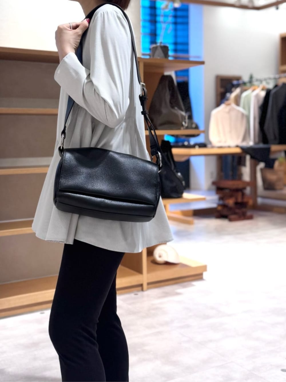 ブラック系のその他パンツ、ブラック系のショルダーバッグ、ホワイト系のTシャツ/カットソーを着用したレディースの冬コーディネートの6枚目の写真