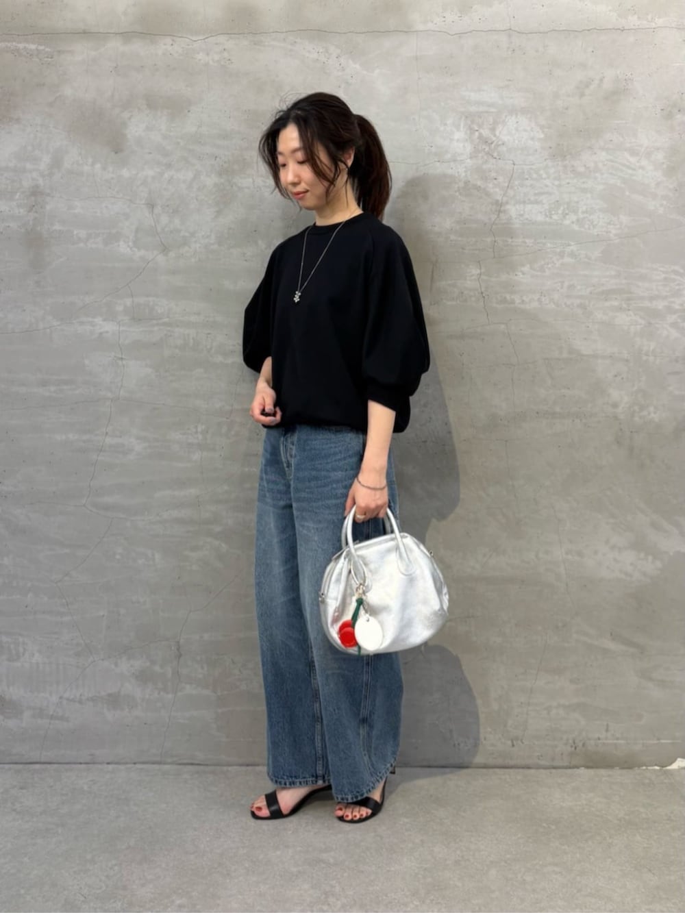 ブルー系のその他パンツ、ブラック系のTシャツ/カットソー、レッド系のチャームを着用したレディースの冬コーディネートの3枚目の写真