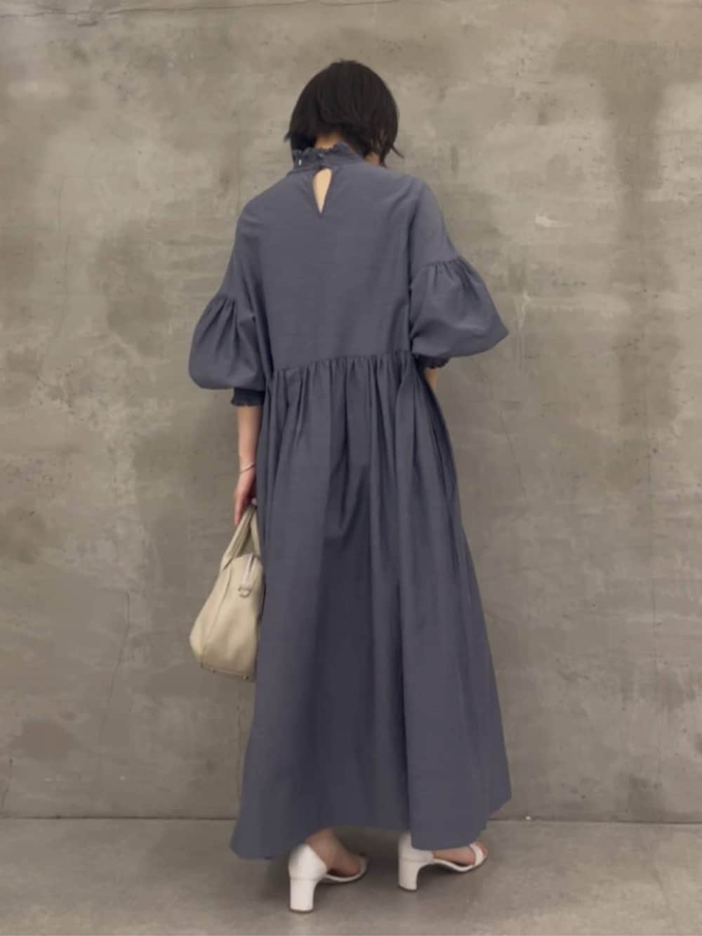 グレー系のボストンバッグ、グレー系のワンピースを着用したレディースの冬コーディネートの5枚目の写真