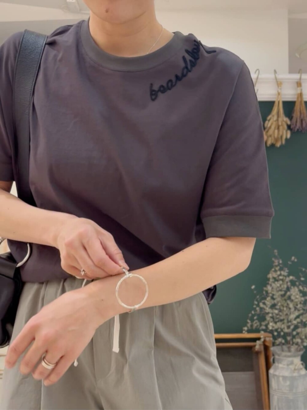 ブラック系のショルダーバッグ、グレー系のTシャツ/カットソー、グレー系のその他パンツを着用したレディースの春コーディネートの5枚目の写真