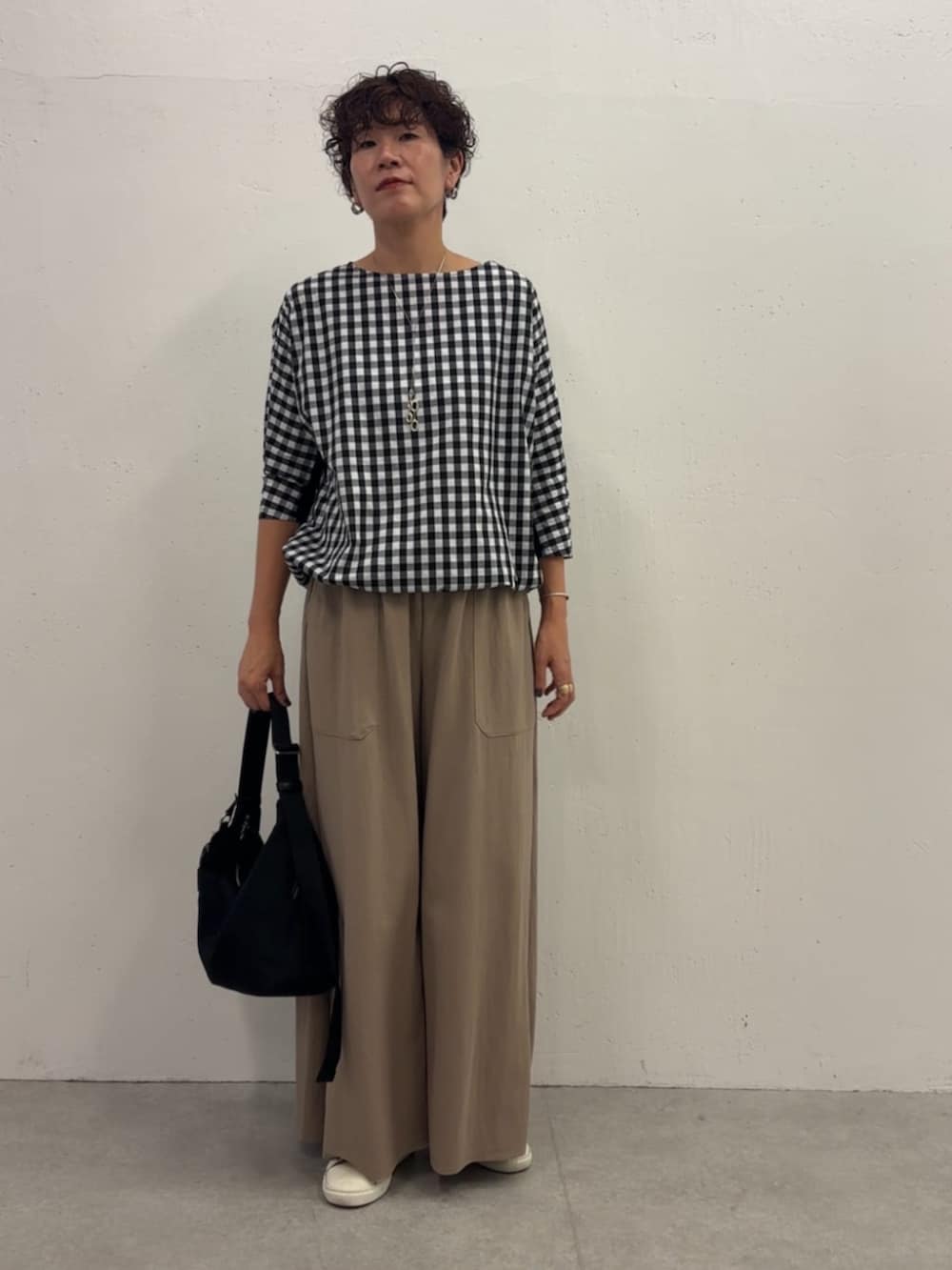 ブラック系のシャツ/ブラウス、ベージュ系のその他パンツ、ブラック系のショルダーバッグを着用したレディースの冬コーディネートの2枚目の写真