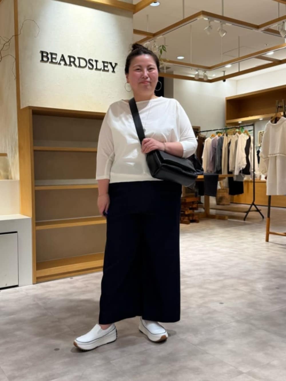 ブルー系のその他パンツ、ブラック系のショルダーバッグ、ホワイト系のシャツ/ブラウスを着用したレディースの春コーディネートの2枚目の写真