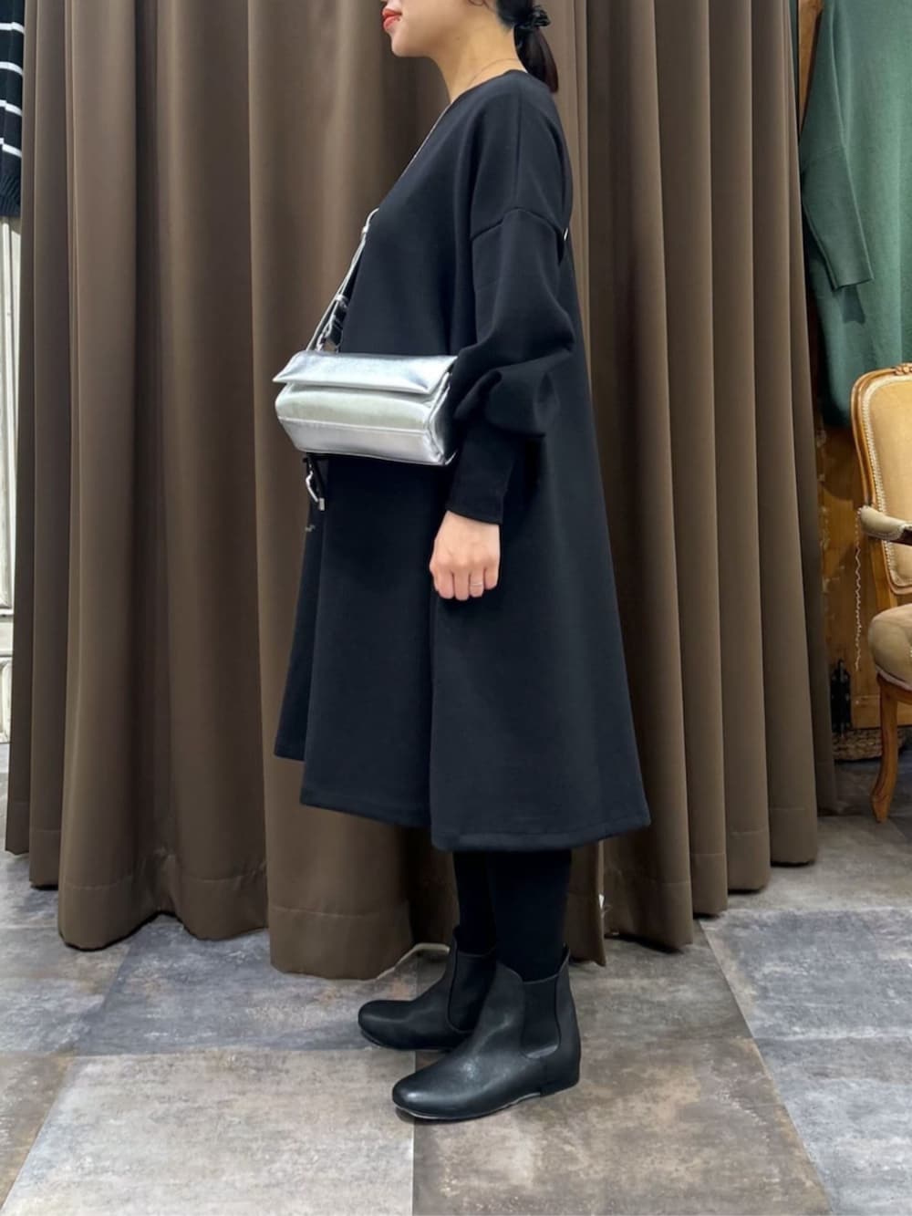 ブラック系のワンピース、ブラック系のチャームを着用したレディースの冬コーディネートの3枚目の写真