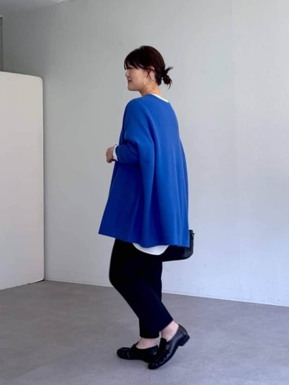 ブラック系のローファー、ブラック系のその他パンツ、ブルー系のニット/セーターを着用したレディースの秋コーディネートの3枚目の写真