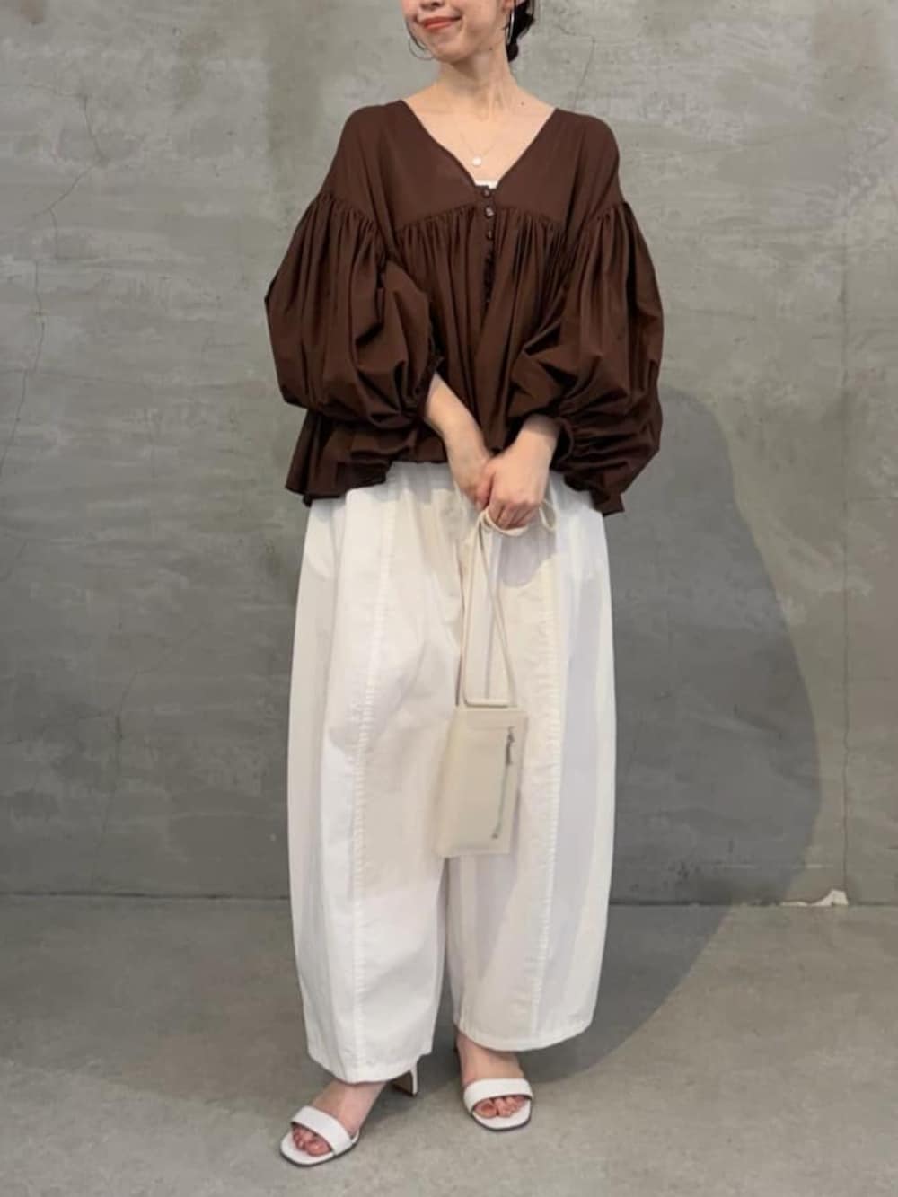 ホワイト系のショルダーバッグ、ホワイト系のその他パンツ、ブラウン系のシャツ/ブラウスを着用したレディースの冬コーディネートの4枚目の写真