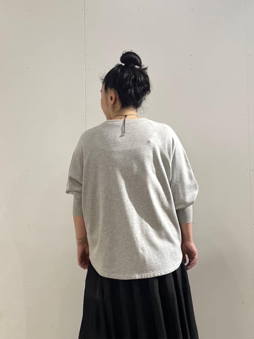 ブラック系のスカート、グレー系のTシャツ/カットソーを着用したレディースの夏コーディネートの5枚目の写真