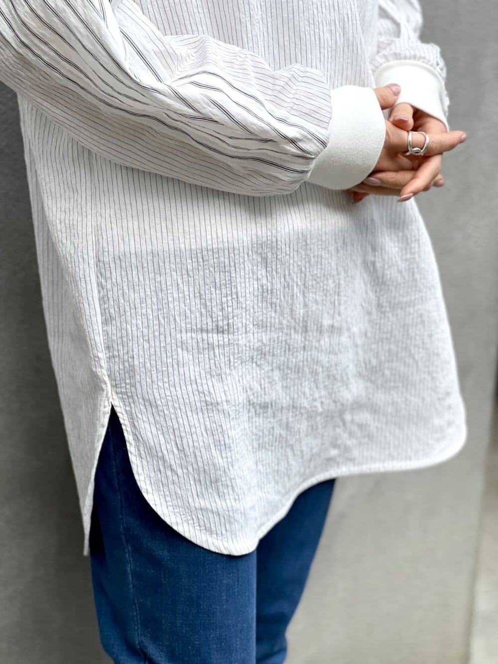 ブラック系のシャツ/ブラウス、ブルー系のデニムパンツ、ホワイト系のスニーカーを着用したレディースの春コーディネートの4枚目の写真