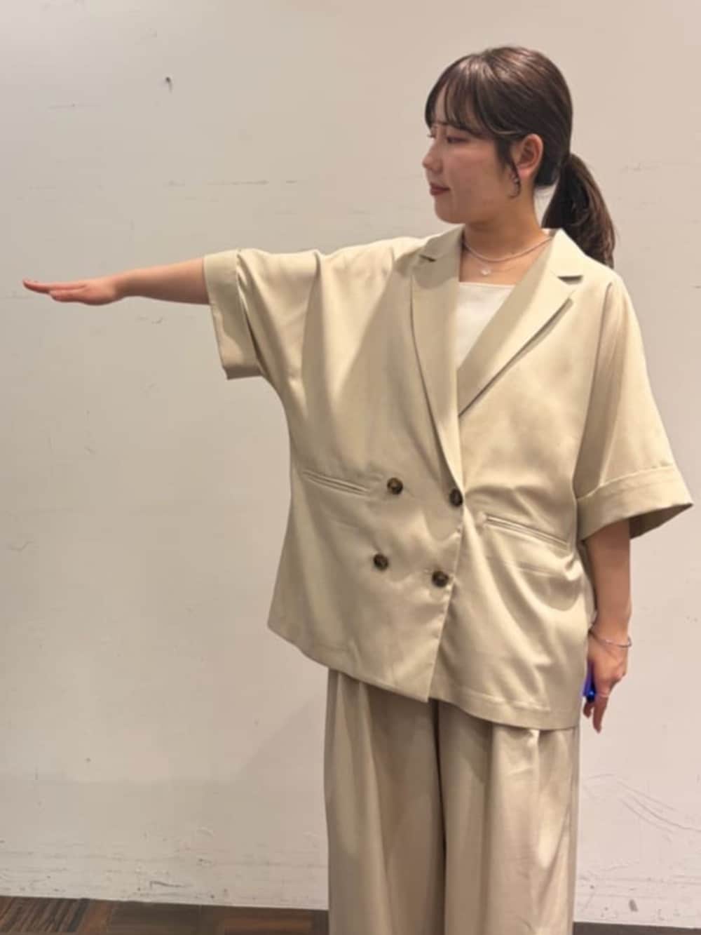 ベージュ系のテーラードジャケット、ベージュ系のその他パンツ、ホワイト系のシャツ/ブラウスを着用したレディースの春コーディネートの4枚目の写真