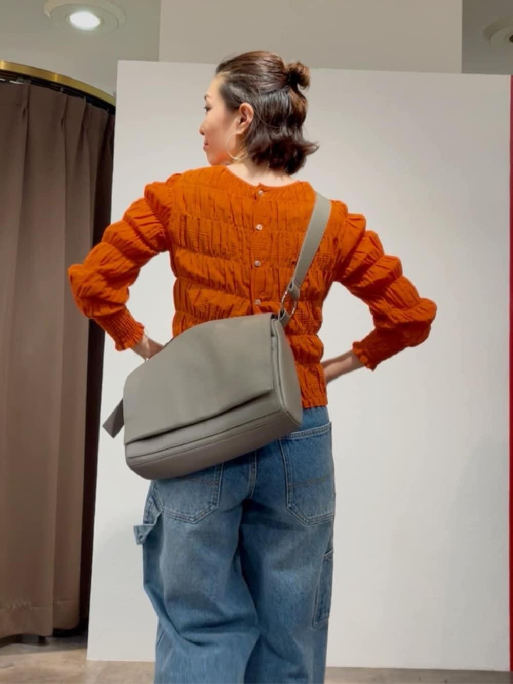 オレンジ系のシャツ/ブラウス、ブルー系のその他パンツ、ホワイト系のサンダルを着用したレディースの春コーディネートの8枚目の写真