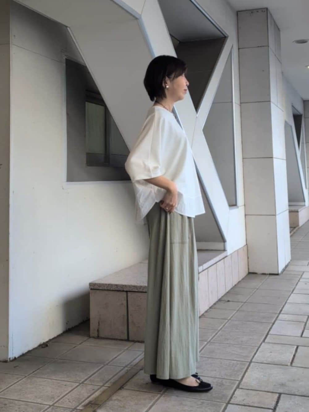 グリーン系のその他パンツ、ホワイト系のTシャツ/カットソーを着用したレディースの春コーディネートの2枚目の写真