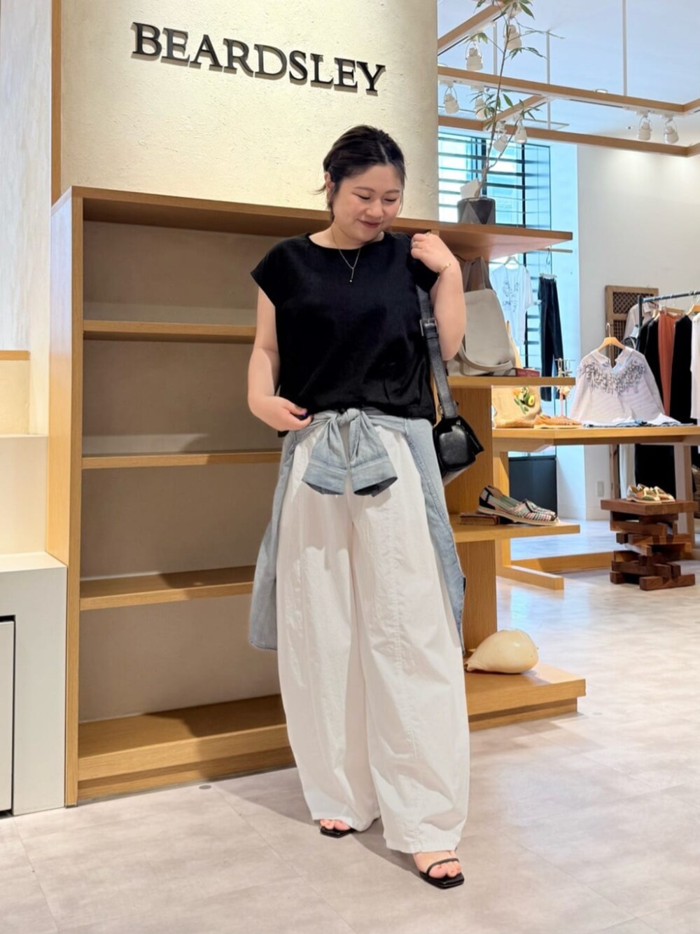 ブラック系のシャツ/ブラウス、ホワイト系のその他パンツを着用したレディースの春コーディネートの4枚目の写真
