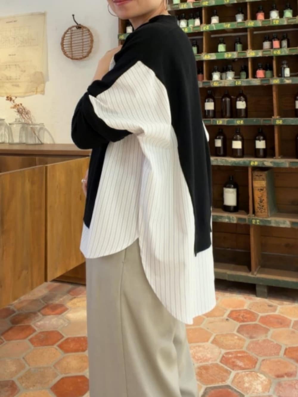 グレー系のその他パンツ、ブラック系のニット/セーターを着用したレディースの秋コーディネートの6枚目の写真