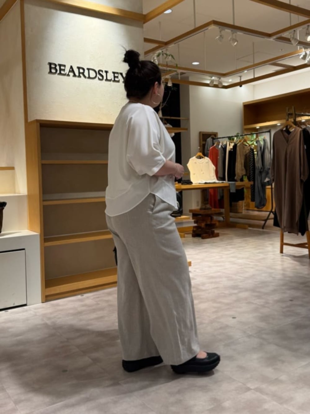 ブラック系のボストンバッグ、ベージュ系のその他パンツ、ホワイト系のTシャツ/カットソーを着用したレディースの春コーディネートの3枚目の写真